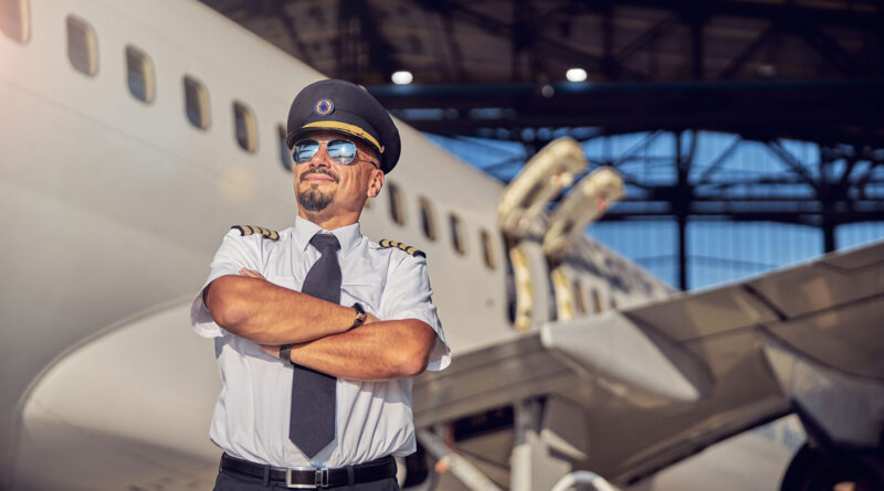 waist-up-portrait-adult-caucasian-man-keeping-arms-crossed-while-standing-front-airplane-near-aviation-hangar